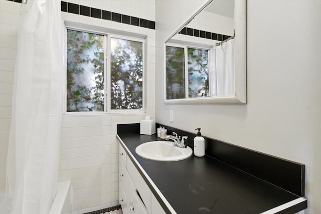 bathroom with shower / bathtub combination with curtain and vanity