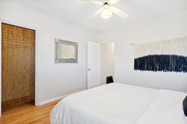 bedroom featuring hardwood / wood-style floors and ceiling fan