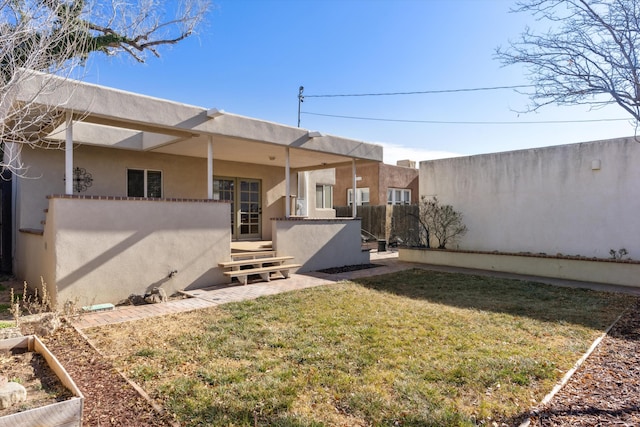 rear view of house with a yard