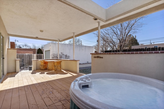 view of patio with a deck and a hot tub