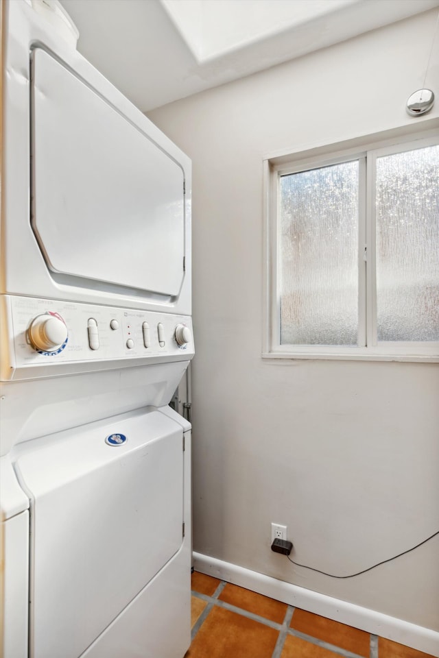 washroom featuring tile patterned floors and stacked washer and dryer