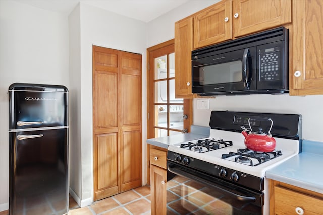 kitchen featuring light tile patterned floors and black appliances