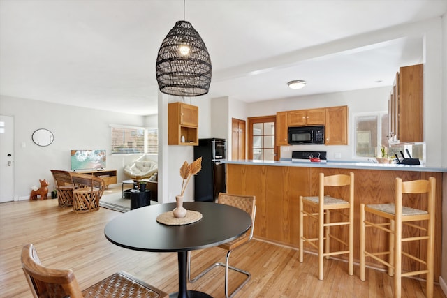 dining area with light hardwood / wood-style floors