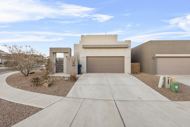 pueblo-style house featuring a garage