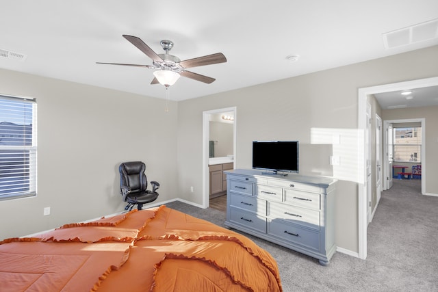 carpeted bedroom with ceiling fan and ensuite bath