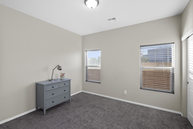 unfurnished bedroom featuring dark colored carpet