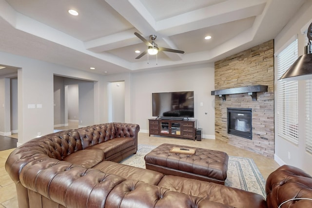 living room with ceiling fan, coffered ceiling, a stone fireplace, beamed ceiling, and light tile patterned flooring