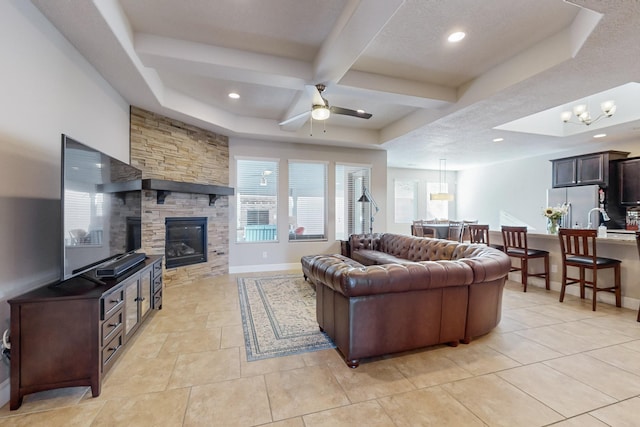 living room with coffered ceiling, a stone fireplace, ceiling fan, light tile patterned floors, and beamed ceiling