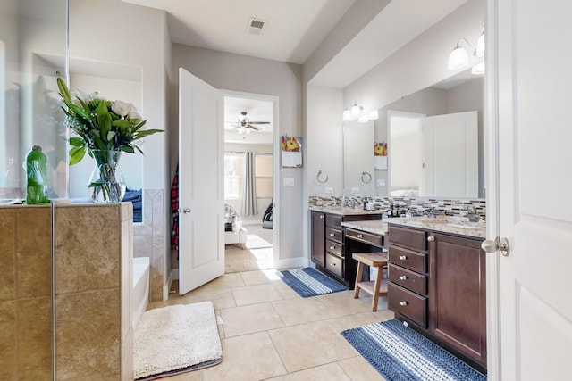 bathroom featuring a tub to relax in, ceiling fan, tile patterned flooring, and vanity