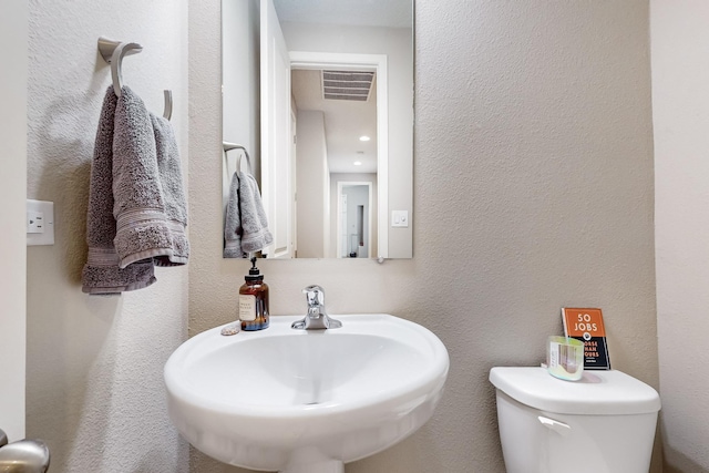 bathroom with toilet and sink