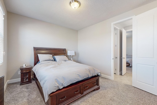 carpeted bedroom featuring a textured ceiling