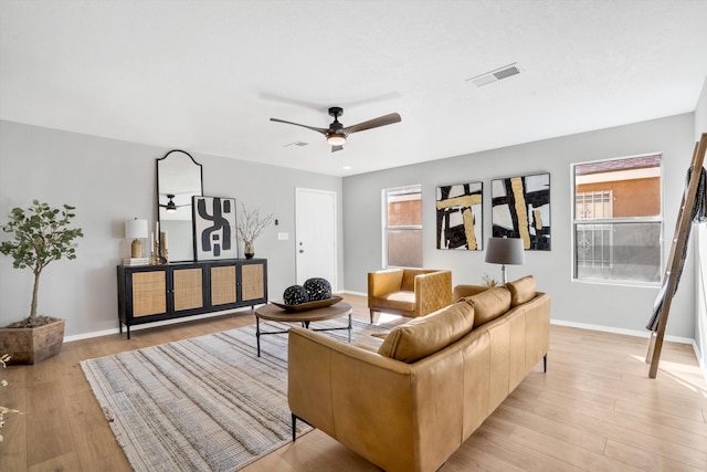 living room with ceiling fan and light wood-type flooring