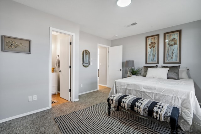 carpeted bedroom featuring connected bathroom