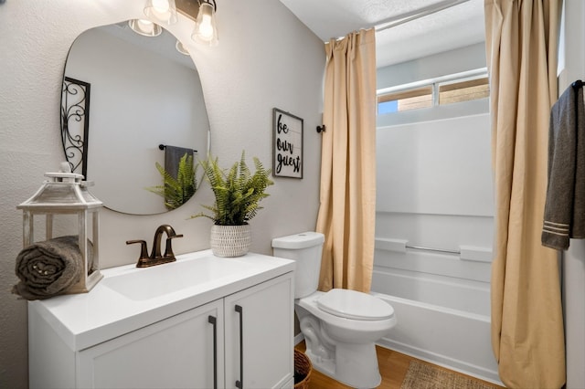 full bathroom with vanity, shower / bath combination with curtain, toilet, a textured ceiling, and wood-type flooring