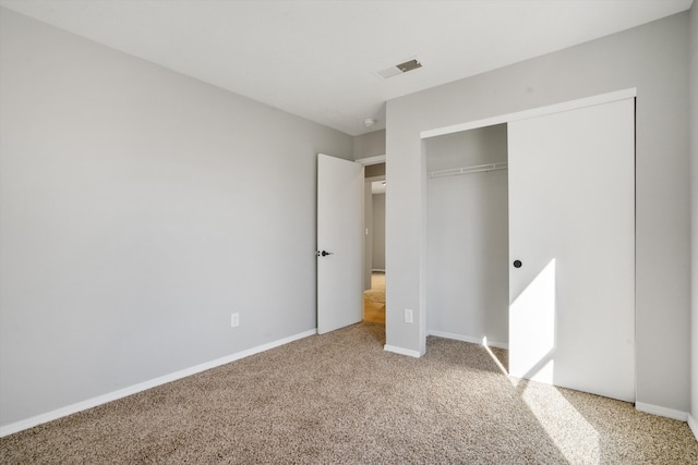 unfurnished bedroom with carpet and a closet