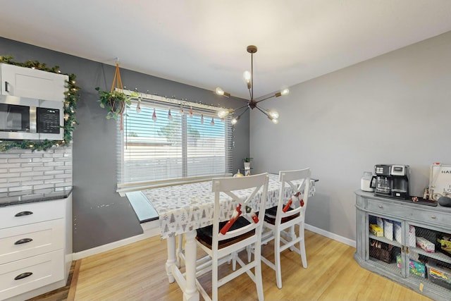 dining room featuring light hardwood / wood-style floors and an inviting chandelier