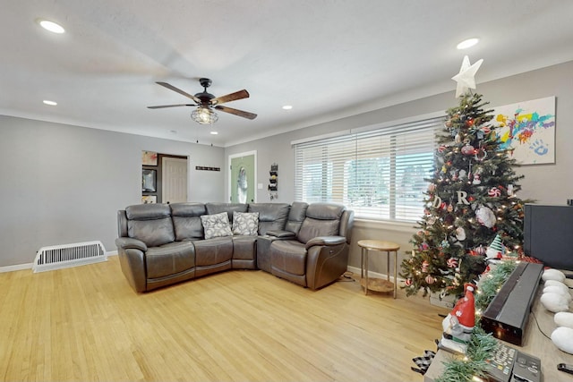 living room with ceiling fan and light hardwood / wood-style flooring