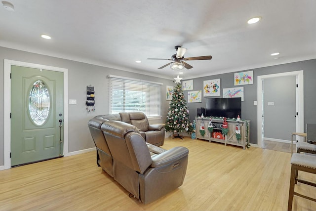 living room featuring ceiling fan and light hardwood / wood-style flooring