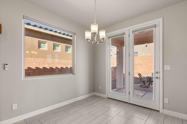 unfurnished dining area with an inviting chandelier