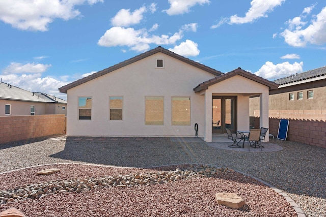 back of house with a patio