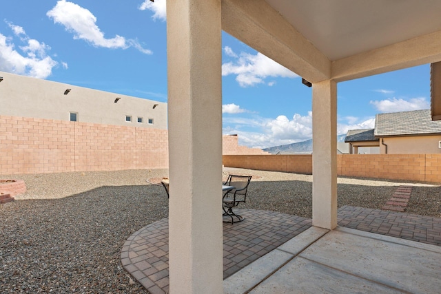 view of patio / terrace featuring a mountain view