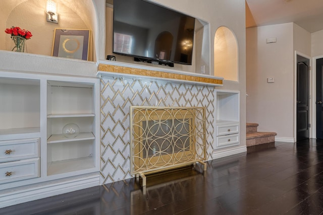 living room featuring dark hardwood / wood-style flooring and built in features