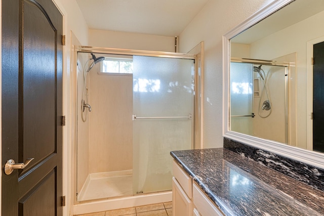 bathroom featuring tile patterned floors, vanity, and an enclosed shower