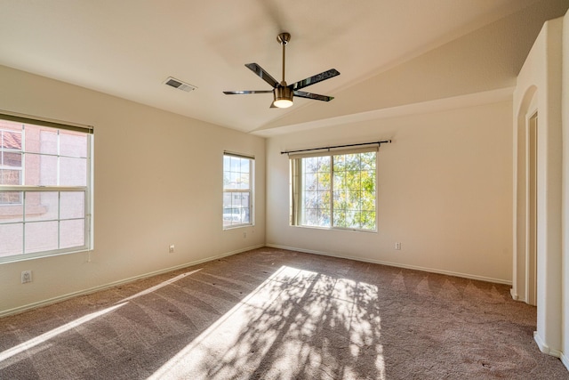 empty room with carpet flooring, ceiling fan, and vaulted ceiling