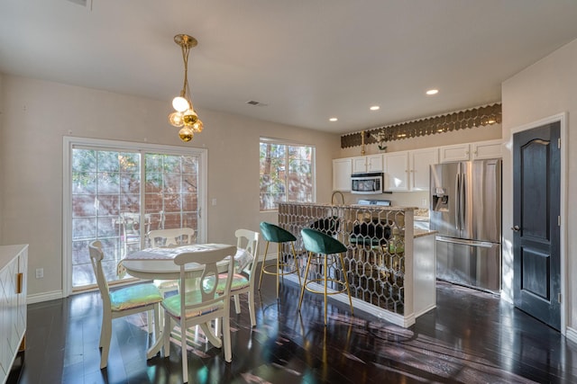 dining space with dark hardwood / wood-style floors