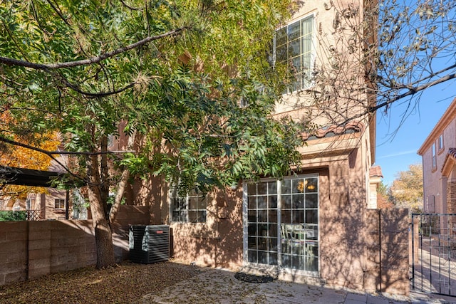 view of side of property with central air condition unit