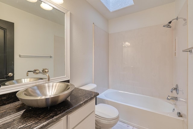 full bathroom with a skylight, vanity,  shower combination, and toilet