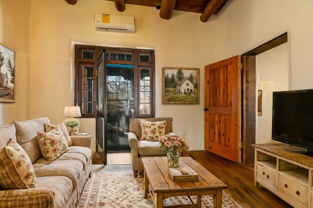 living room featuring beam ceiling, a wall unit AC, and hardwood / wood-style flooring