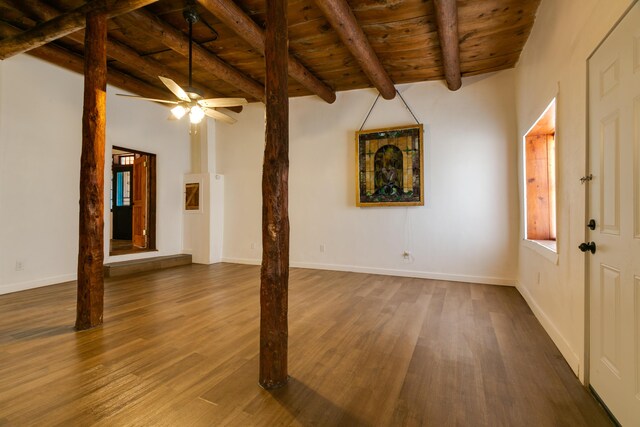 interior space featuring wooden ceiling, dark hardwood / wood-style floors, lofted ceiling with beams, and ceiling fan