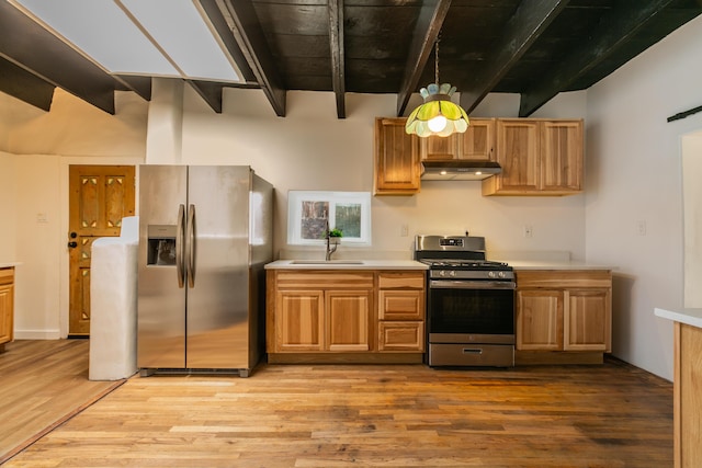 kitchen with stainless steel appliances, light countertops, a sink, and under cabinet range hood