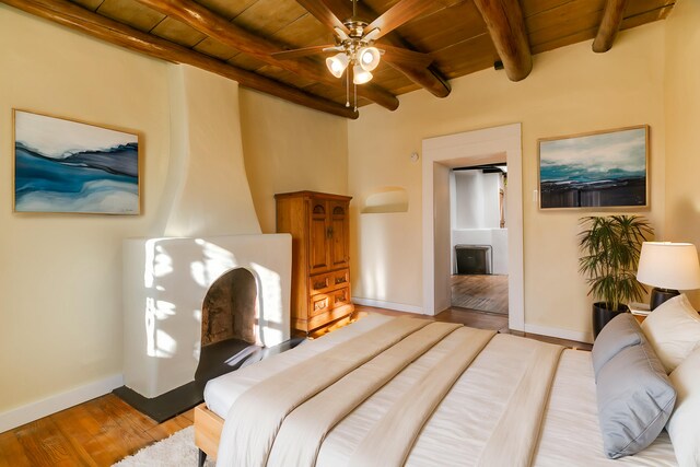 living room with ceiling fan, light hardwood / wood-style flooring, beam ceiling, and wood ceiling