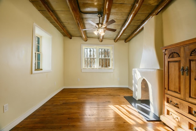 living room with ceiling fan, wooden ceiling, baseboards, light wood finished floors, and beamed ceiling