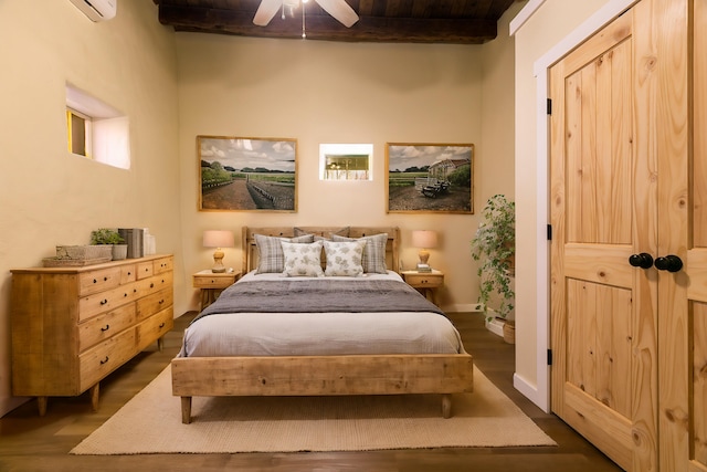 bedroom with ceiling fan, baseboards, dark wood finished floors, and beamed ceiling