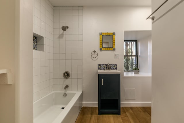 bathroom with shower / washtub combination, vanity, baseboards, and wood finished floors