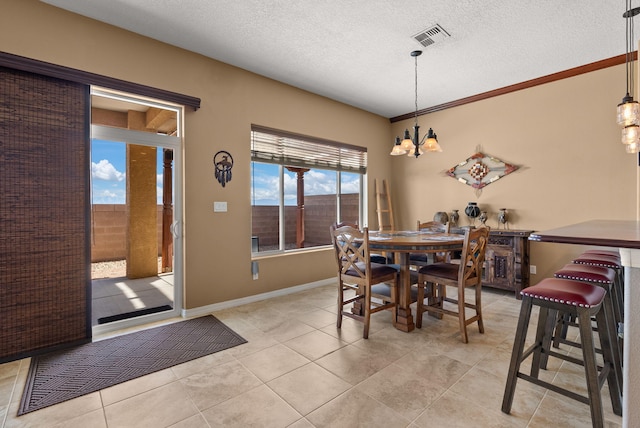 tiled dining area featuring a textured ceiling and a chandelier