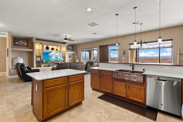 kitchen with pendant lighting, a center island, sink, stainless steel dishwasher, and ceiling fan