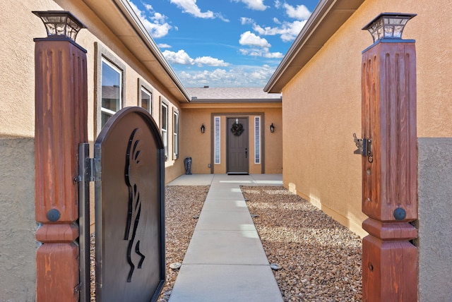 entrance to property featuring stucco siding