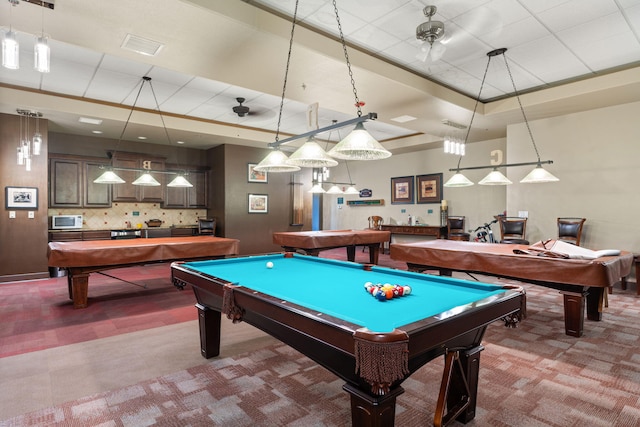 game room featuring carpet flooring, a raised ceiling, and pool table