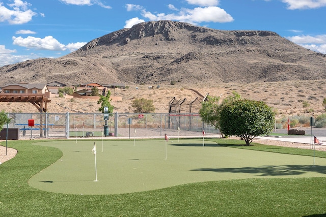 view of community featuring fence and a mountain view