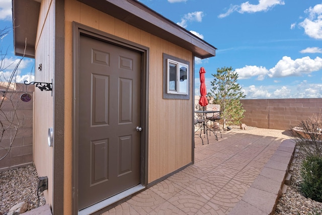 doorway to property featuring a patio area and fence