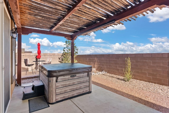 view of patio / terrace with a hot tub