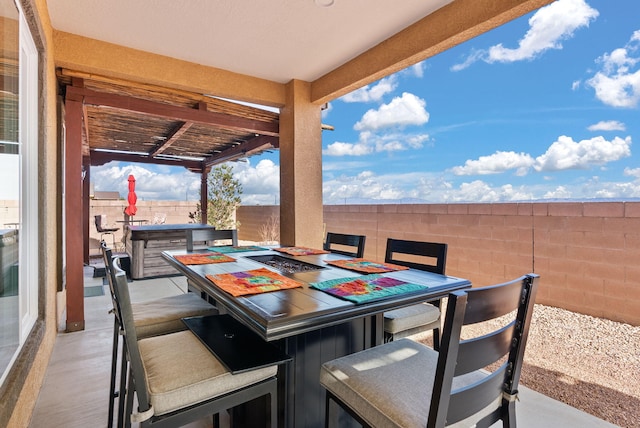 view of patio with an outdoor bar and a fire pit