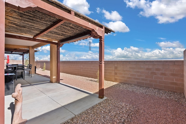 view of patio featuring outdoor dining space, a fenced backyard, and a pergola