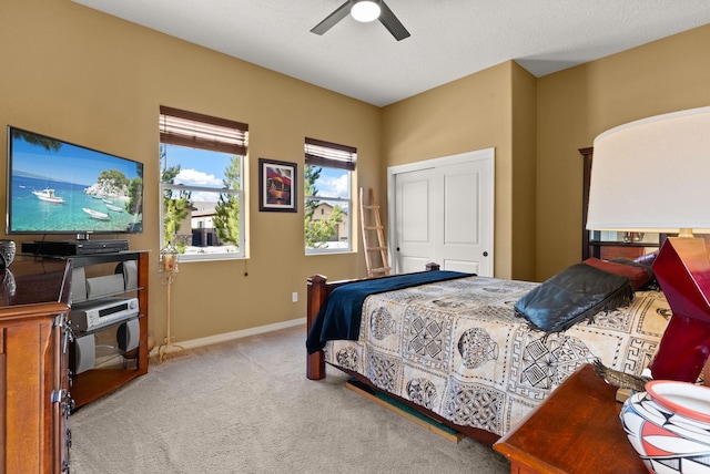 carpeted bedroom featuring a closet and ceiling fan