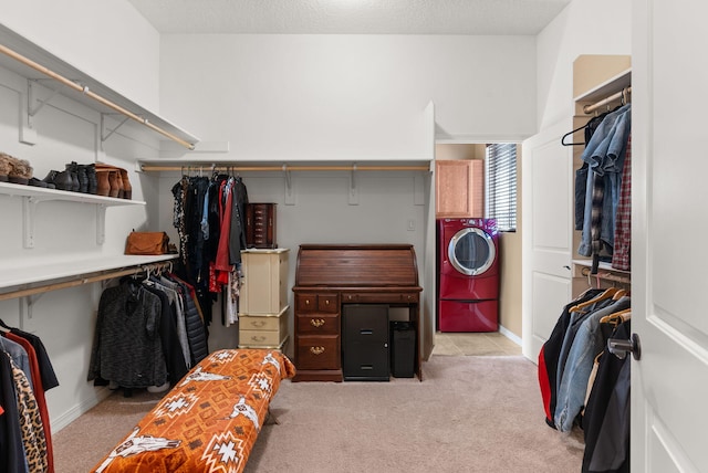 walk in closet featuring light colored carpet and washer / clothes dryer