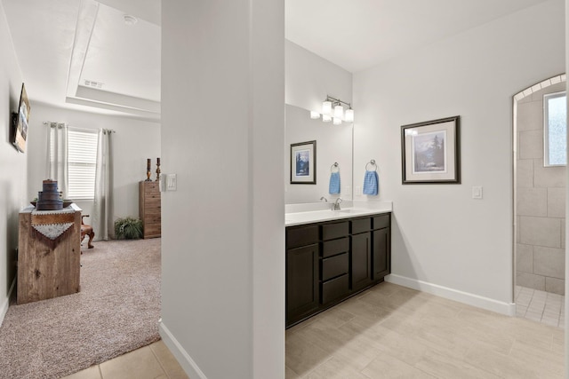 full bathroom featuring a healthy amount of sunlight, tile patterned floors, baseboards, and vanity